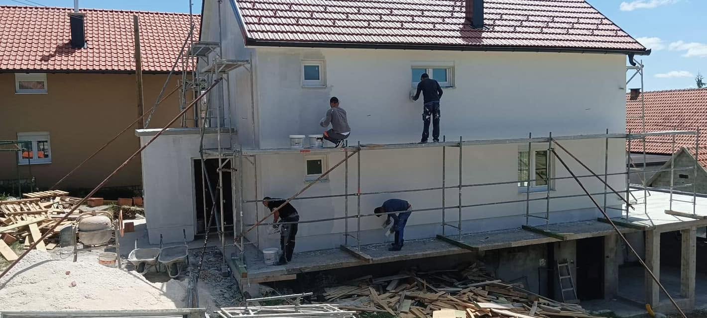 Radnici izvode završne fasadne radove na kući
